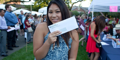 female student holding a financial aid check