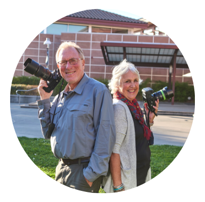 two older adults with cameras