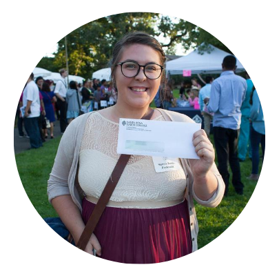 female student holding a financial aid check